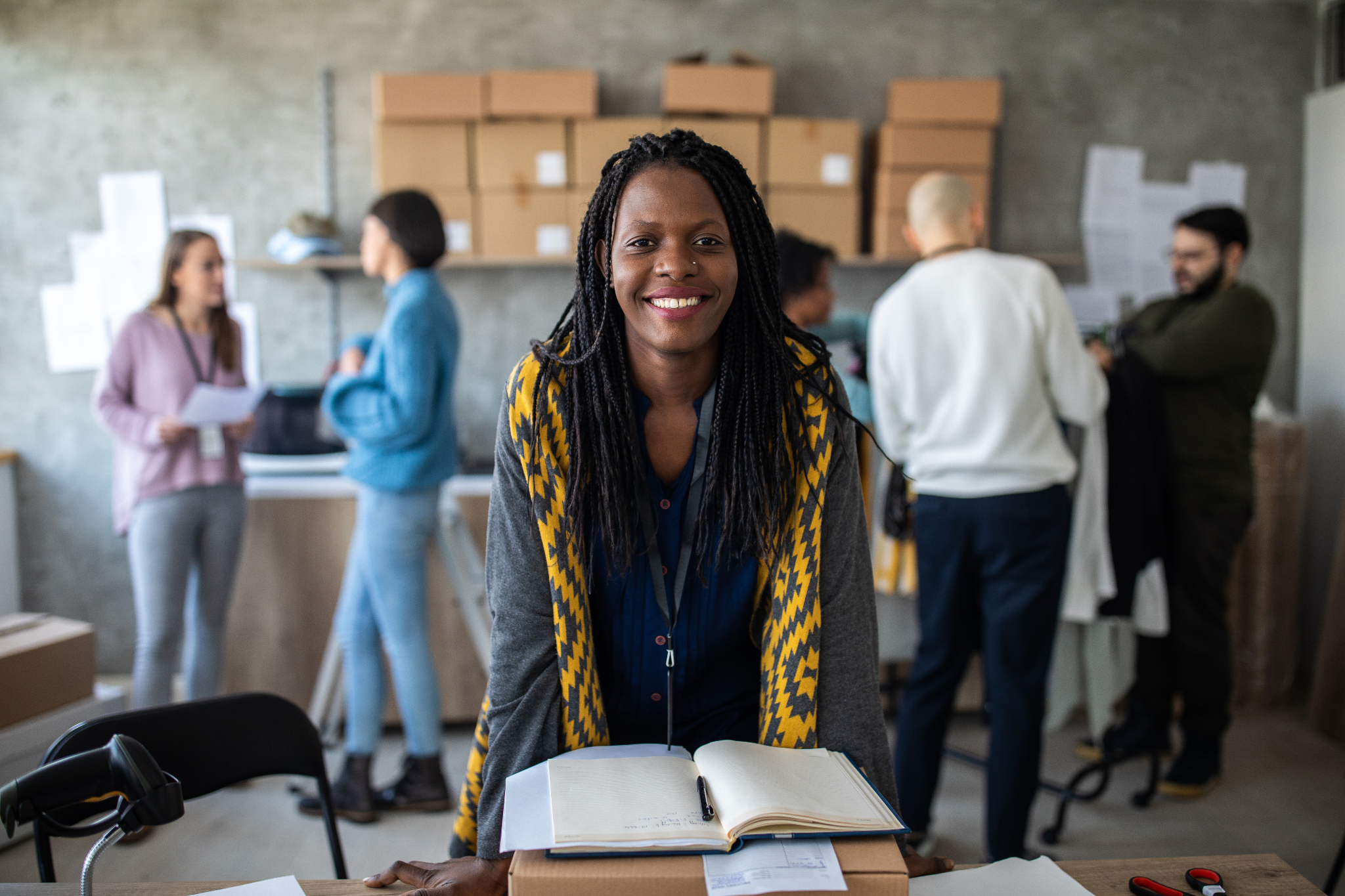 Small-business owner at work in a busy warehouse